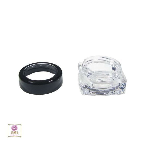 A Cosmetic Jars with a Black Trim Acrylic Window Lid open sitting next to a square clear beauty container base