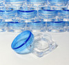 Small square cosmetic sample jars with a clear square jar base and a blue lid