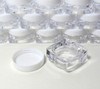 Tiny square cosmetic sample jars with a jar base and a white lid