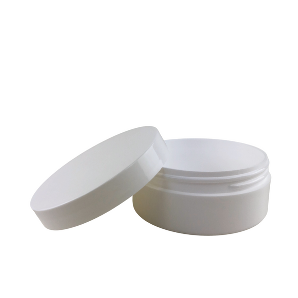 A sleek, white, wide mouth plastic jar with a thick wall construction with lid sitting next to the jar.