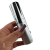 A hand holding a beautiful high-end silver skincare pump bottle