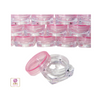 A stack of mini square cosmetic jars with pink lids in the back and a clear square jar base in the front with the jar lid sitting next to it